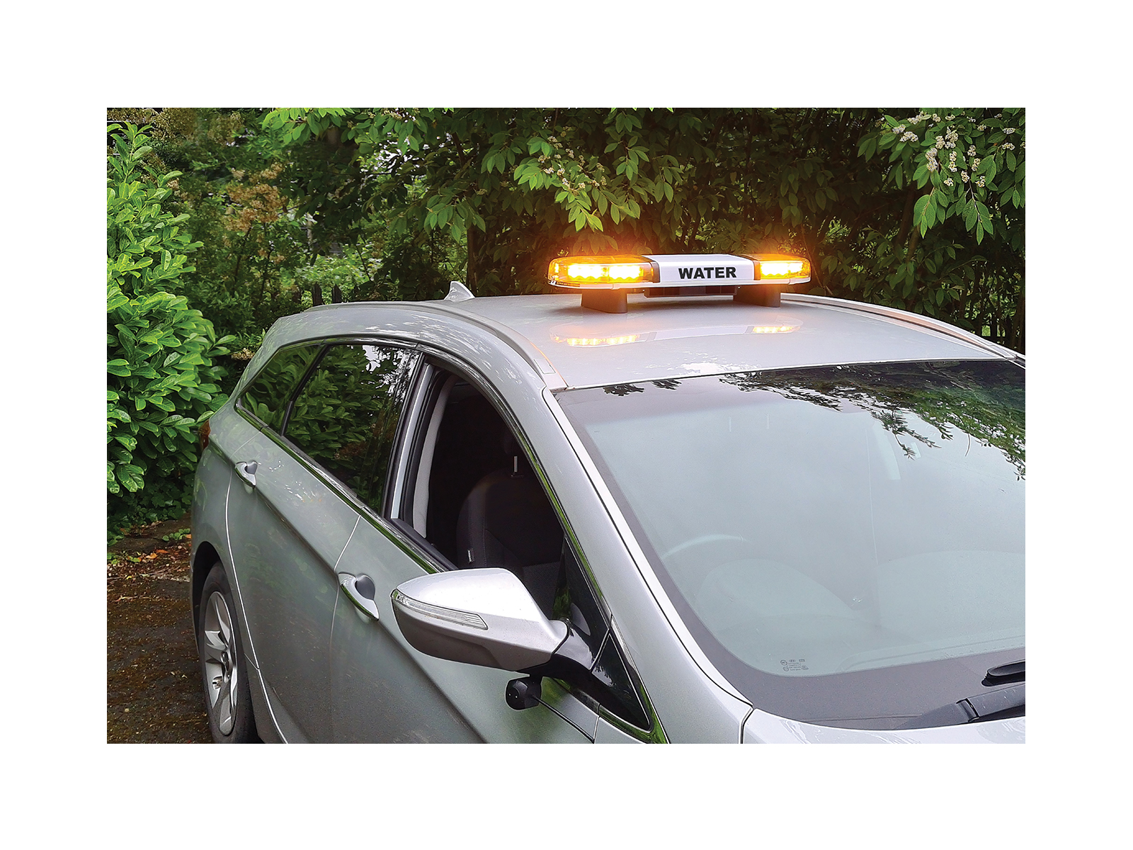 Hurricane PA Lightbar with 60 Watt Speaker Driver In Situ Angle View Lit Water Livery on Roof of Silver Car